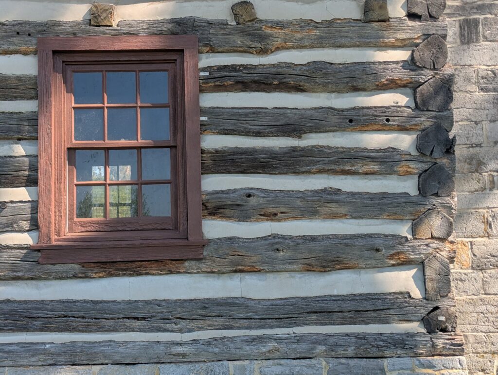 Close-up of hewn logs and limestone chinking on the Flohr House exterior