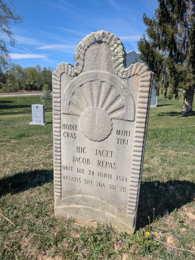1814 headstone of Jacob Repas with rising-sun relief, carved by Laurence Krone
