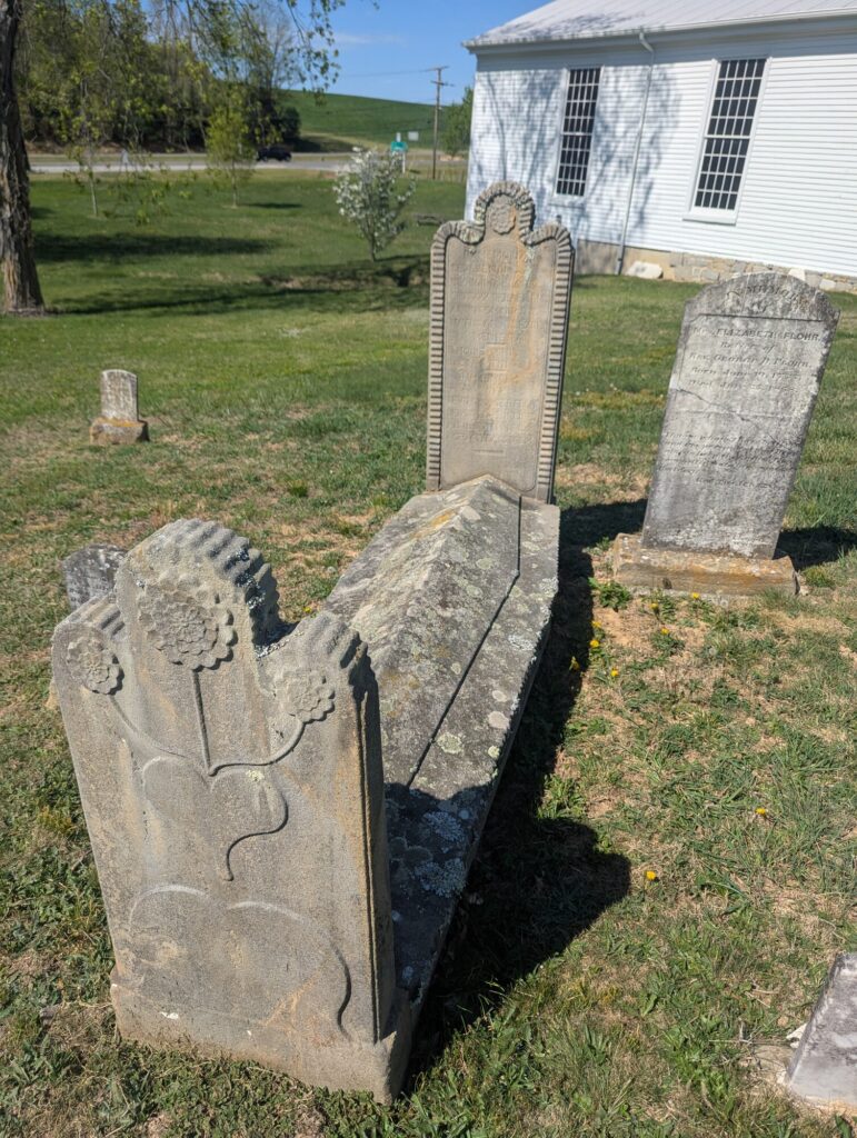 Three sandstone headstones carved with Laurence Krone signature sunflower relief